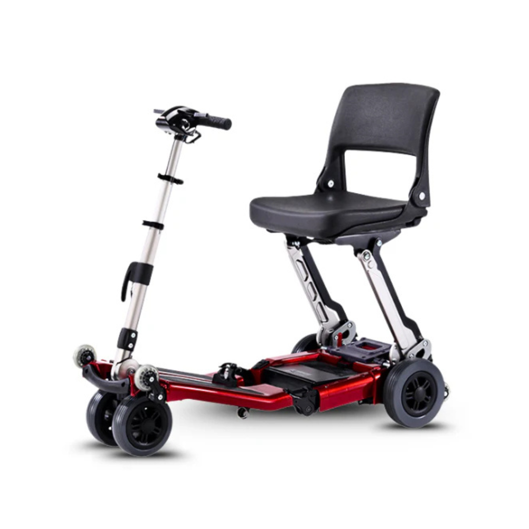 The FreeRider Luggie Standard Travel Scooter is a compact, lightweight, foldable scooter featuring a black seat, silver adjustable steering column, and red frame for easy transport and accessibility.
